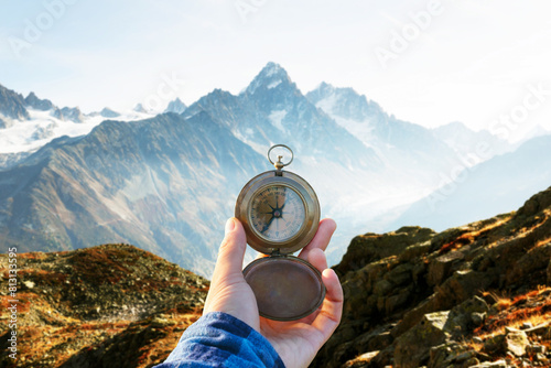 Monte Bianco mountains range and tourist hand with old metal compass photo