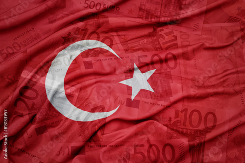 waving colorful national flag of turkey on a euro money banknotes background. finance concept.