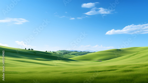 Rolling green hills under a clear blue sky  creating a picturesque and idyllic rural landscape