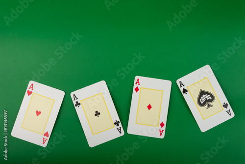 Cuadro en lienzo Playing cards isolated on green background.