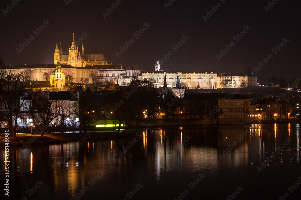 Illuminated Hradcany (Prague Castle)  and Charles Bridge,  St. Vitus Cathedral and St. George church, medieval architecture, Vltava river at night, Bohemia, Czech Republic.