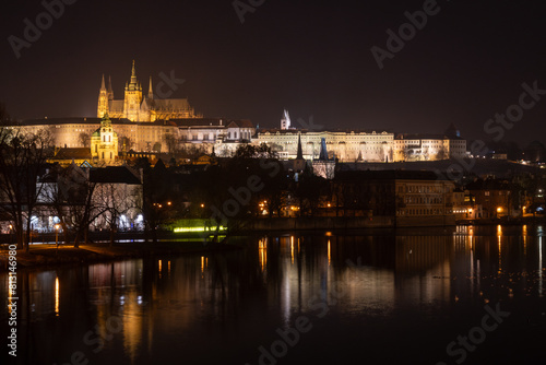 Illuminated Hradcany (Prague Castle) and Charles Bridge, St. Vitus Cathedral and St. George church, medieval architecture, Vltava river at night, Bohemia, Czech Republic.