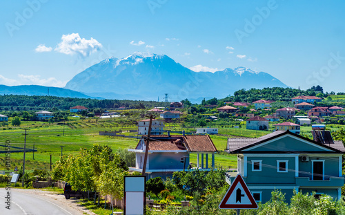 A view approaching  a village in Albasan county near Belsh Lakes, Albania in summertime photo