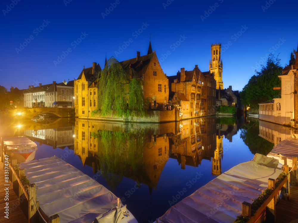Bruges, Belgium. Historic part of the city. Architectural landscape during the blue hour. Reflections on the surface of the water. Picture for wallpaper, postcards, background, design.