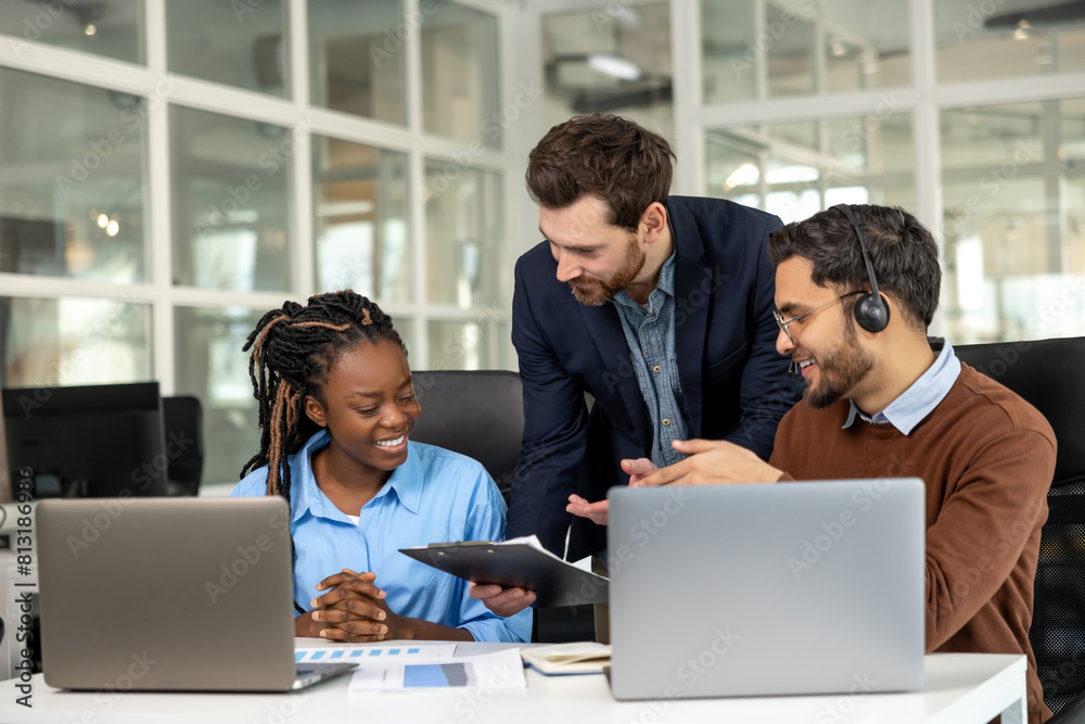 Diverse colleagues collaborating on project together Diverse colleagues collaborating on project together