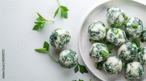 herb infused cheese balls with fresh parsley on a white plate