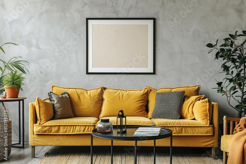 Chic living space with a mustard yellow fabric sofa and a black metal table, complemented by a framed mockup on a soft gray wall.