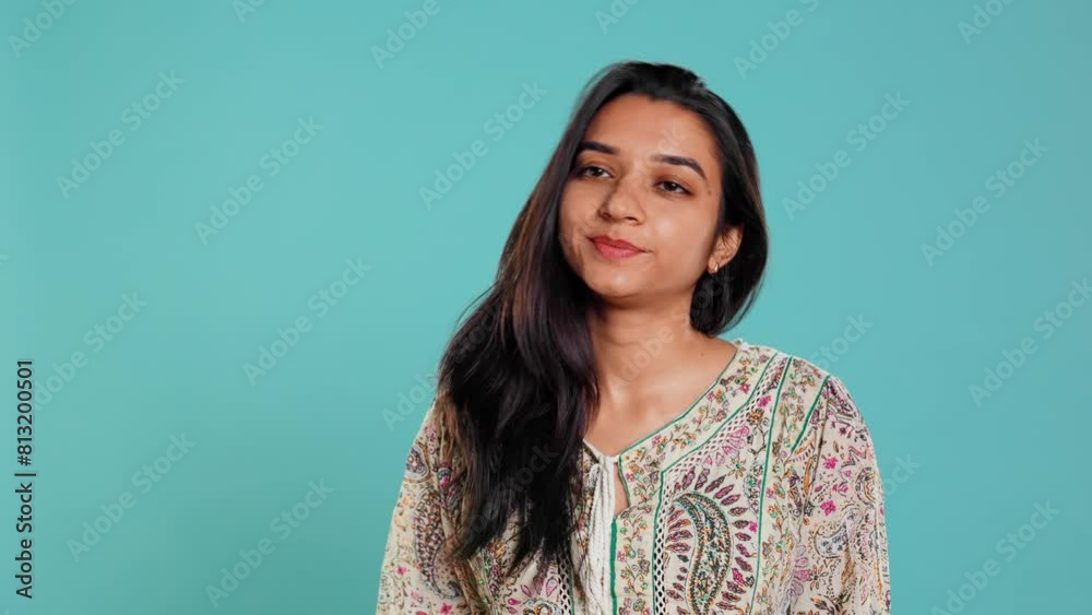 Portrait of cheerful friendly indian woman smiling, flipping long healthy hair, isolated over studio background. Happy brunette person confident with natural hairstyle, feeling satisfied, camera B Portrait of cheerful friendly indian woman smiling, flipping long healthy hair, isolated over studio background. Happy brunette person confident with natural hairstyle, feeling satisfied, camera B