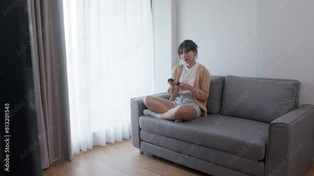 Happy woman streaming and watching movies on couch Happy woman streaming and watching movies on couch