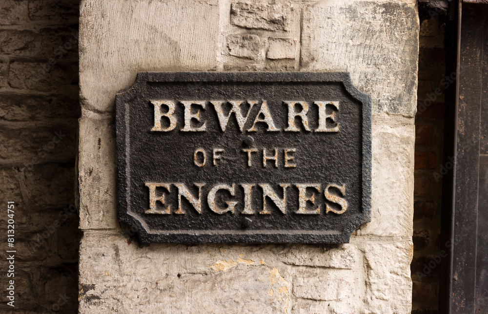 Beware of the engines sign, UK. Steampunk AI anxiety concept