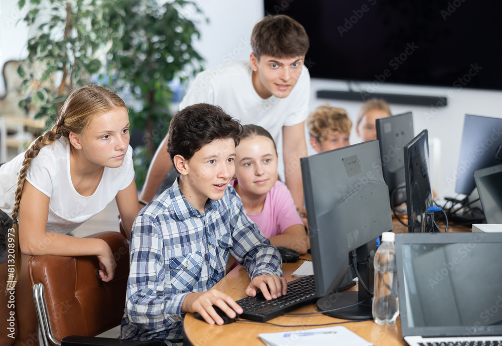 Fototapeta premium Group of children students learning to use computer in classroom