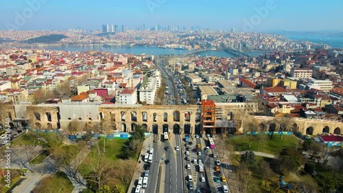Istanbul's Stone Arch: 4K Drone Video Footage of Aerial View of Historical Arch and City Traffic photo