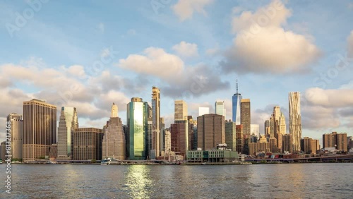 New York Manhattan skyline time lapse - city skyscrapers hyper lapse moving clouds. NYC towers in United States of America - tall modern buildings of financial district in urban metropolis downtown.