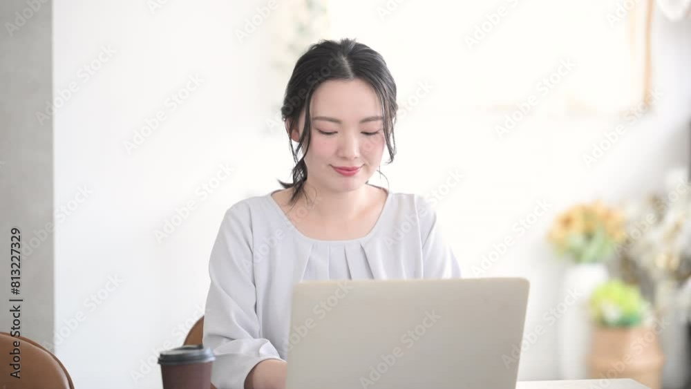 Young cute woman smiling for the camera while at the computer Front Young cute woman smiling for the camera while at the computer Front