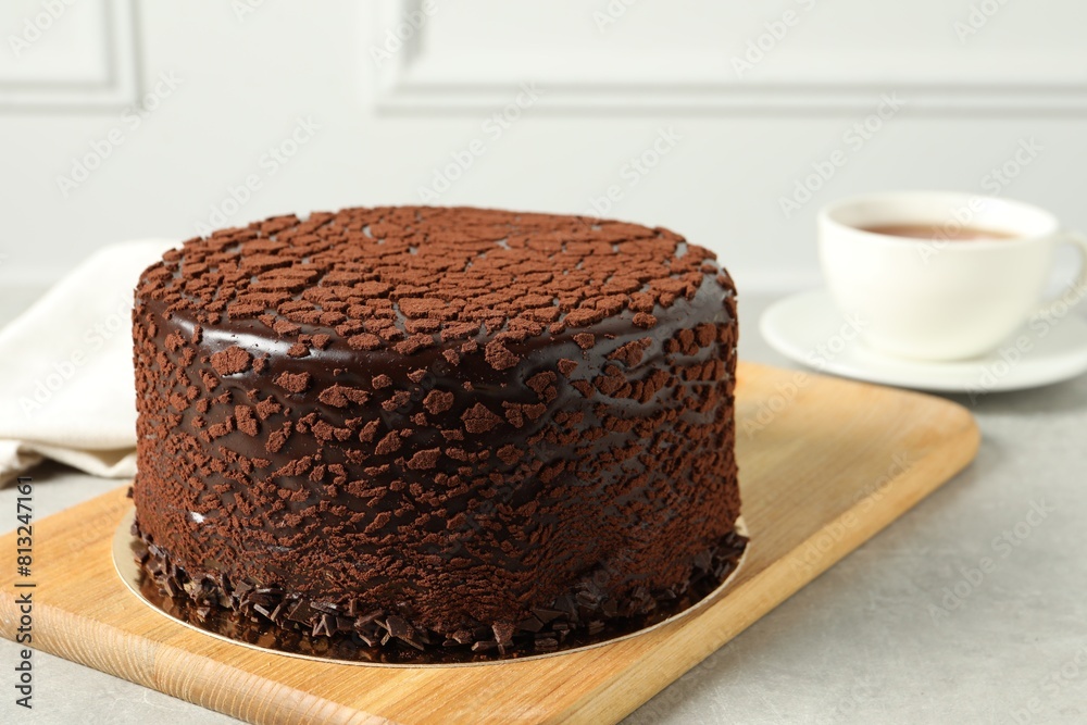 Delicious chocolate truffle cake on light grey table Delicious chocolate truffle cake on light grey table