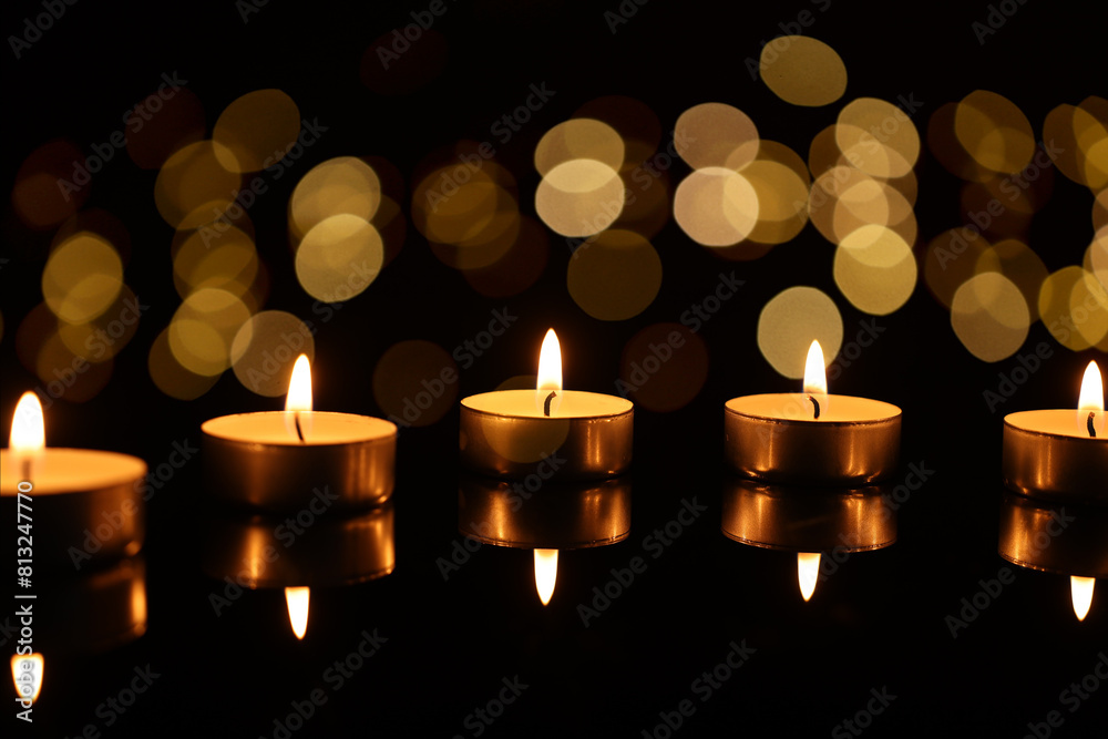 Burning candles on mirror surface in darkness, bokeh effect Burning candles on mirror surface in darkness, bokeh effect