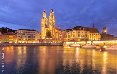 Famous Grossmunster churche and river Limmat at night in Old Town of Zurich  Switzerland