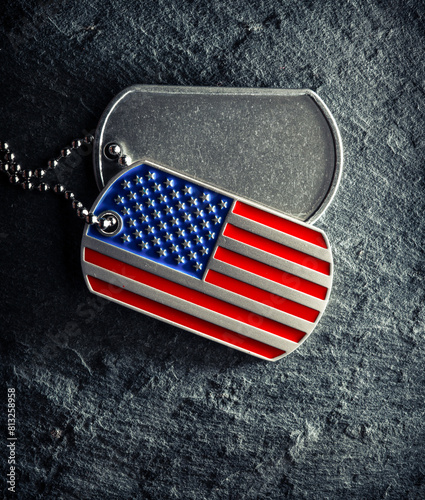 US military soldier's dog tags, rough and worn with blank space for text, and in the shape of the American flag. Memorial Day for Veterans Day concept.