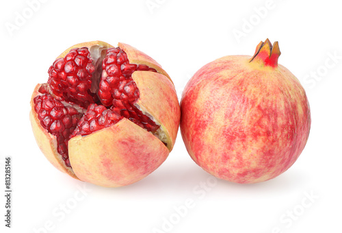 A whole pomegranate and a half pomegranate on a white background. The pomegranate on the left is whole and has a deep red color. clipping path.