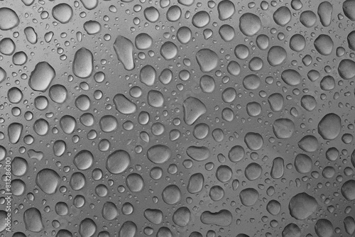 Rainwater Droplets on Shiny Metallic Chrome Silver Background.