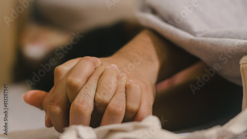 Fotografie Hands of couple lovers having sex on a bed in morning with lust and love, Close up hands of a couple having sex on a bed