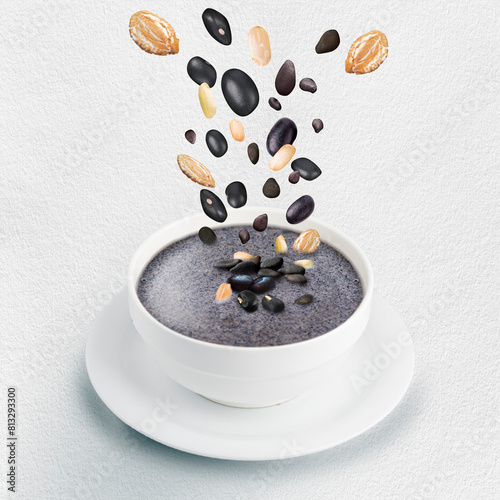 Bowl of black seasame milk mix more cereal on white background