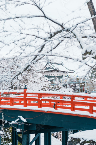 White Hirosaki Castle or Takaoka Castle and red bridge with snow in winter, hirayama style Japanese castle located in Hirosaki city, Aomori Prefecture, Tohoku, Japan. Landmark for tourist attraction photo