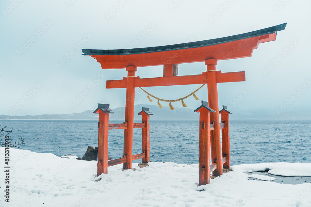 Red Japanese Torii gate of Goza no Ishi Shrine at lake tazawa in winter, located in Semboku city, Akita Prefecture, northern Japan. Landmark and famous for tourists attractions in Tohoku region, Japan Red Japanese Torii gate of Goza no Ishi Shrine at lake tazawa in winter, located in Semboku city, Akita Prefecture, northern Japan. Landmark and famous for tourists attractions in Tohoku region, Japan