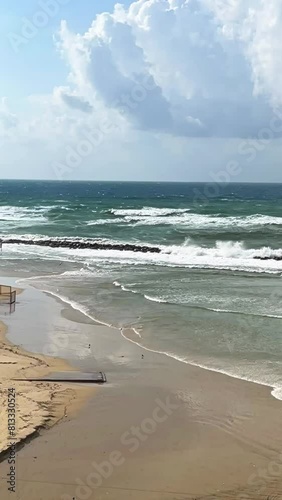 Aerial top view of a clear blue sea with beautiful waves on a sunny day in summer