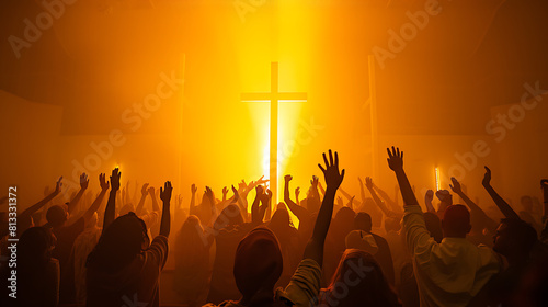 Christian worshipers raise their hands up in the air with large crucifix sign