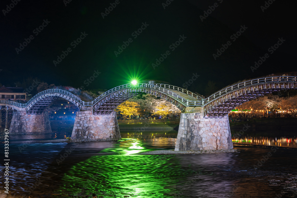 Obraz premium Kintai Bridge Illuminated at night. Cherry blossoms along the Nishiki River bank. The Sakura festival. Iwakuni, Yamaguchi Prefecture, Japan.