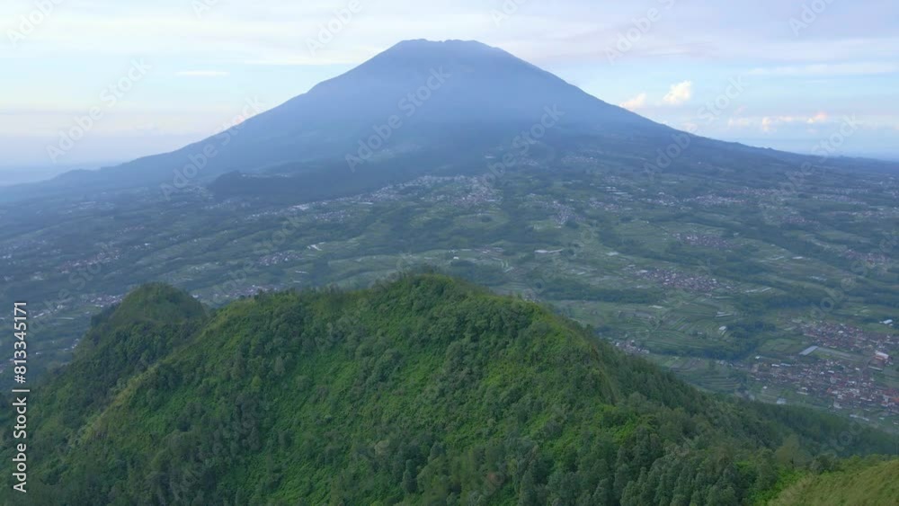 Aerial view of beautiful natural landscape. Slope of Telomoyo Mountain with Merbabu mountain on the background. Aerial view of beautiful natural landscape. Slope of Telomoyo Mountain with Merbabu mountain on the background.