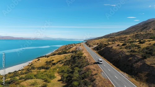 Van Driving On Road Near Lake Pukaki On South Island Of New Zealand. drone following shot photo