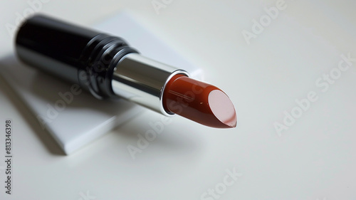 A chic and sophisticated chestnut lipstick showcased on a pure white surface  offering a rich and luxurious shade.
