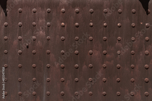 Rusty steel plate with pattern of rivets  © Cam