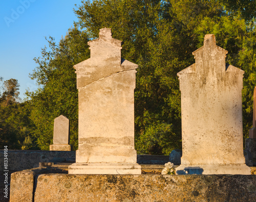 old stone matching headstones in cemetery © Cam