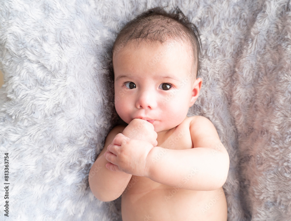 Japanese naked baby boy sucks his thumb and looks at camera Japanese naked baby boy sucks his thumb and looks at camera