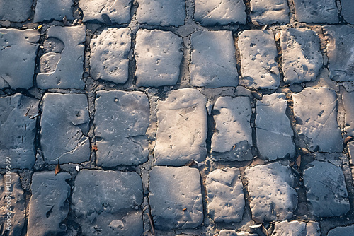 Old stone wall texture with rough granite blocks and cobblestone pavement, ideal for abstract architecture or construction backgrounds photo