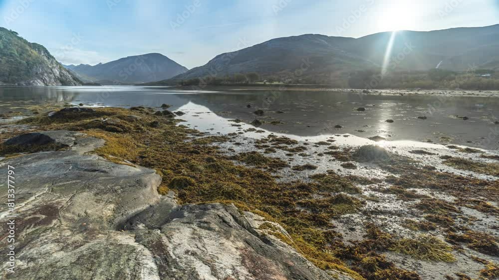 The rising tide slowly covers the sandy bottom and reaches for the rocky shore in a timelapse video. The rising tide slowly covers the sandy bottom and reaches for the rocky shore in a timelapse video.