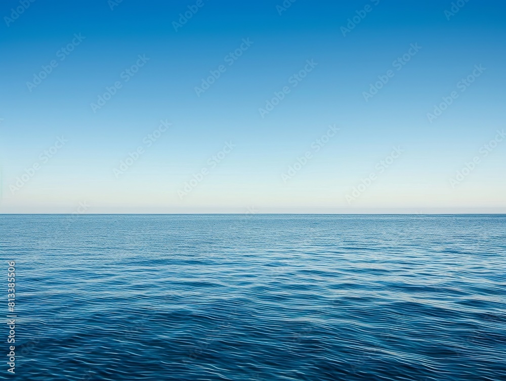 A vast expanse of clear blue sky meets the sparkling ocean, with fluffy white clouds drifting overhead A vast expanse of clear blue sky meets the sparkling ocean, with fluffy white clouds drifting overhead