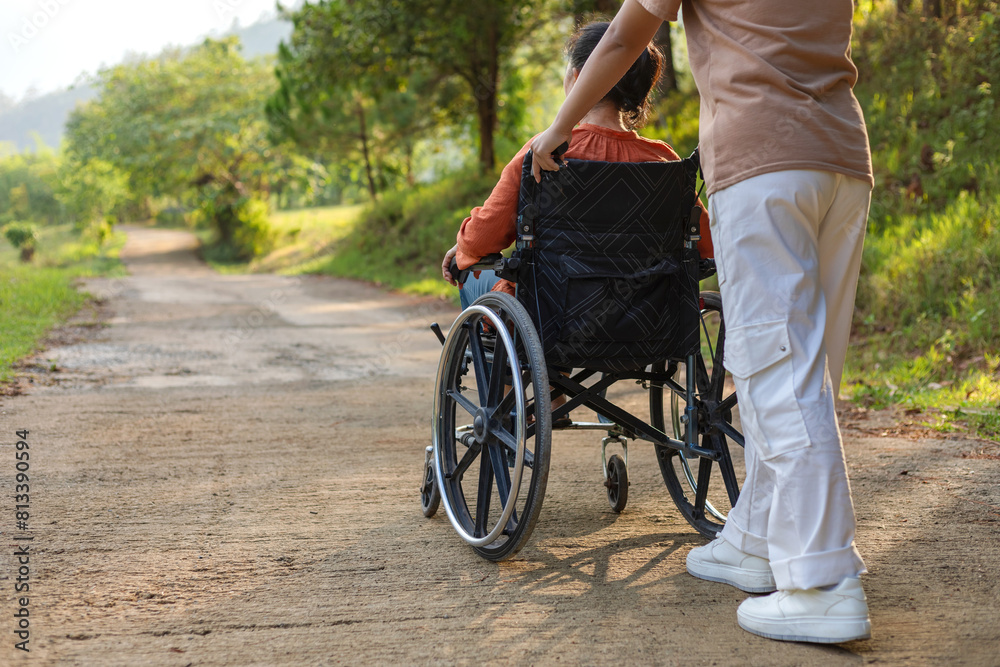 Senior women with wheelchair and care helper walking park Senior women with wheelchair and care helper walking park