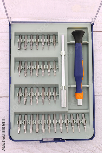 Universal tool box, tool kit closeup with set of hex, torx and screwdriver bits, and various sizes of ratchet wrench sockets