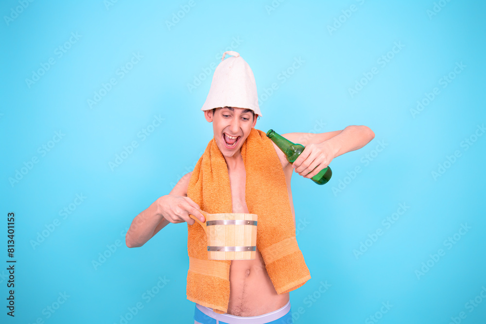 Healthy lifestyle. Retro style. A young attractive man is steaming in a Finnish sauna. Blue background.