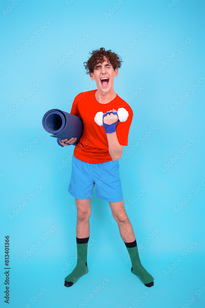 Fitness and healthy lifestyle. Retro style. A young attractive man goes in for sports. Blue background. Fitness and healthy lifestyle. Retro style. A young attractive man goes in for sports. Blue background.