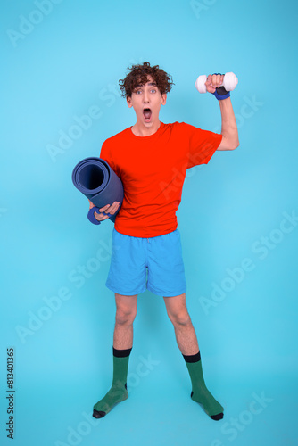 Fitness and healthy lifestyle. Retro style. A young attractive man goes in for sports. Blue background.