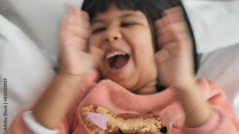 child clapping hands and smiling, sitting on sofa . child clapping hands and smiling, sitting on sofa .