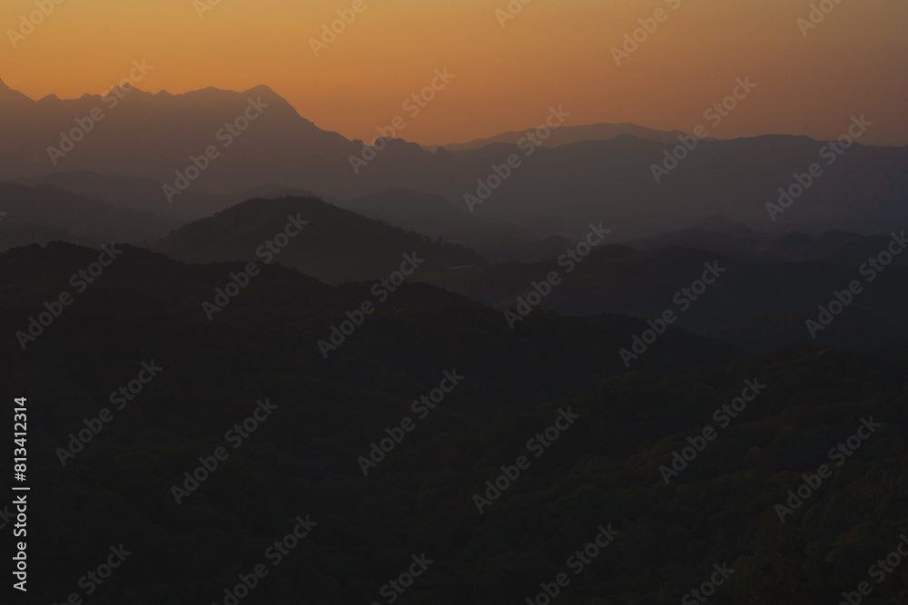 nature traveling with orange sky and layer of mountain with sunrise background nature traveling with orange sky and layer of mountain with sunrise background