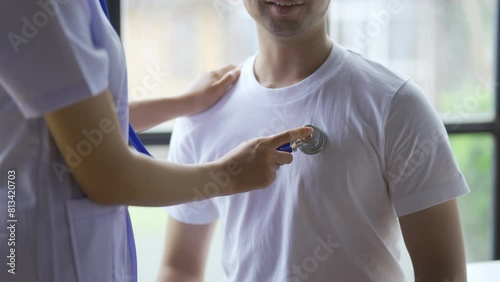 Close up of doctor is using a stethoscope listen to the heartbeat of the patient. Doctor giving a male patient a check up. photo