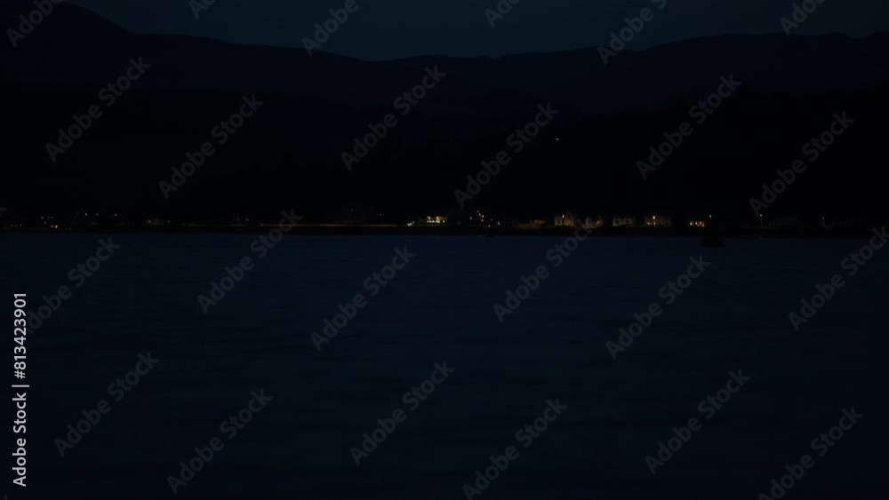 Distant lights of seaside town at night Distant lights of seaside town at night