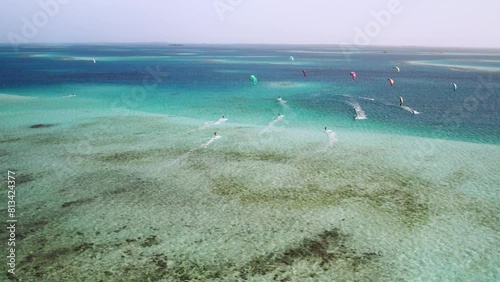 Kite surfers gliding over the clear waters at cayo vapor, vibrant aquatic scene, aerial view